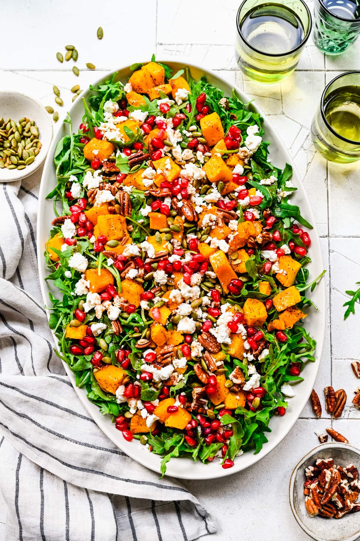 Finished pumpkin salad on a white oval platter.