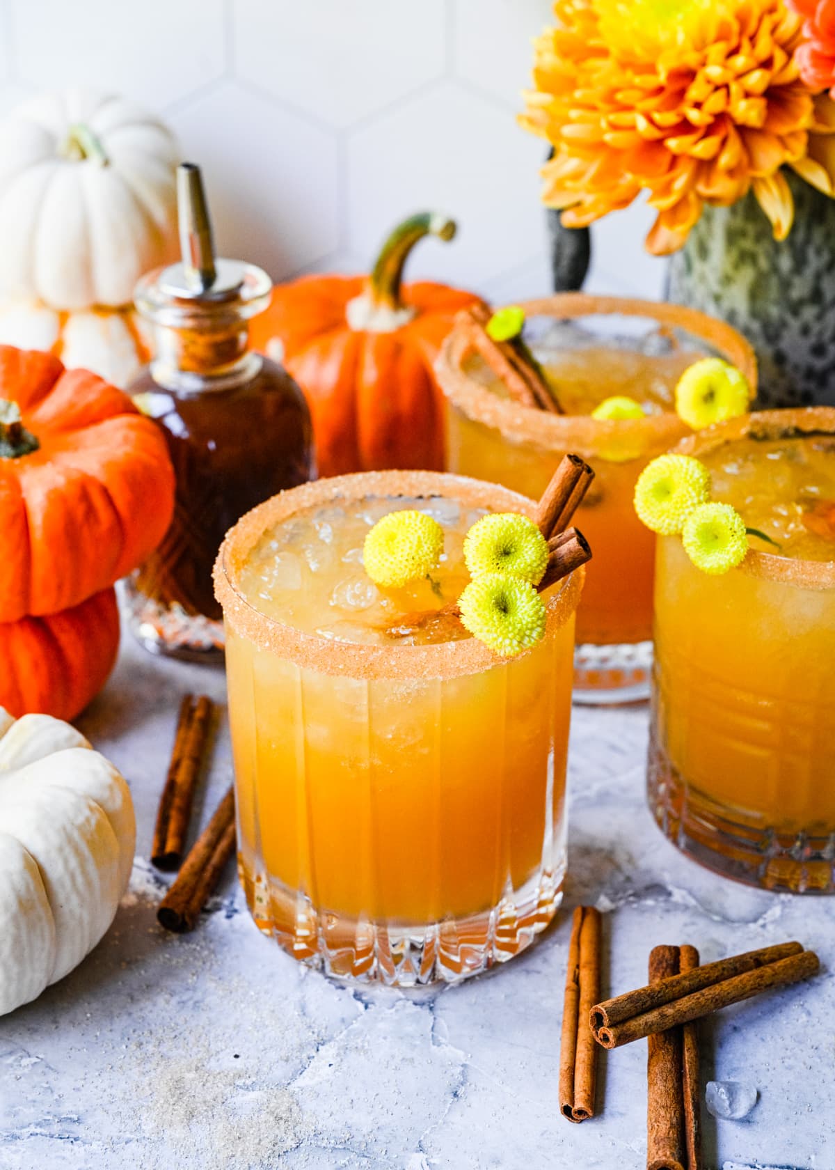 Close up view of pumpkin spice margaritas with cinnamon sugar rim.