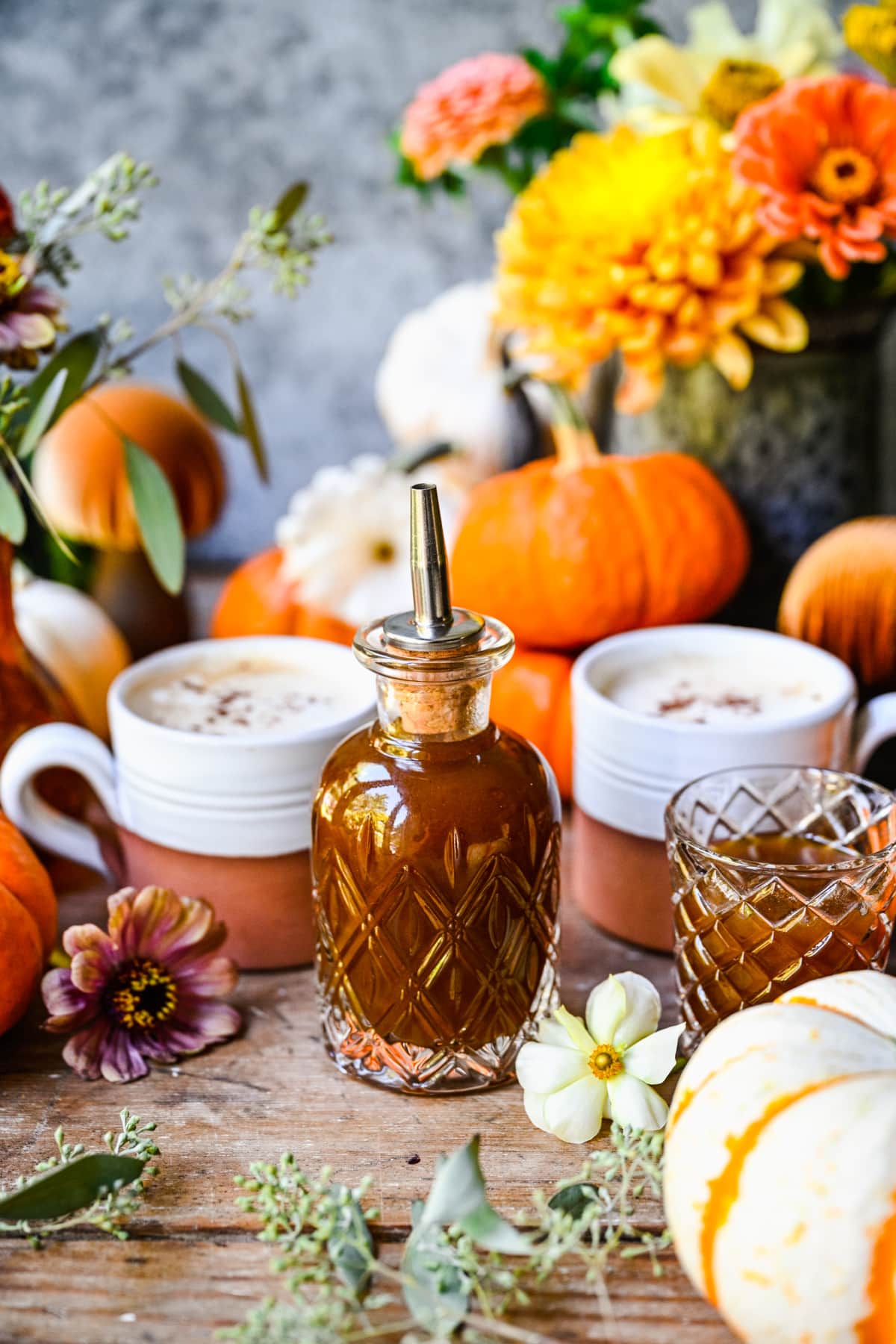 Pumpkin pie simple syrup in a glass bottle with fall backdrop.