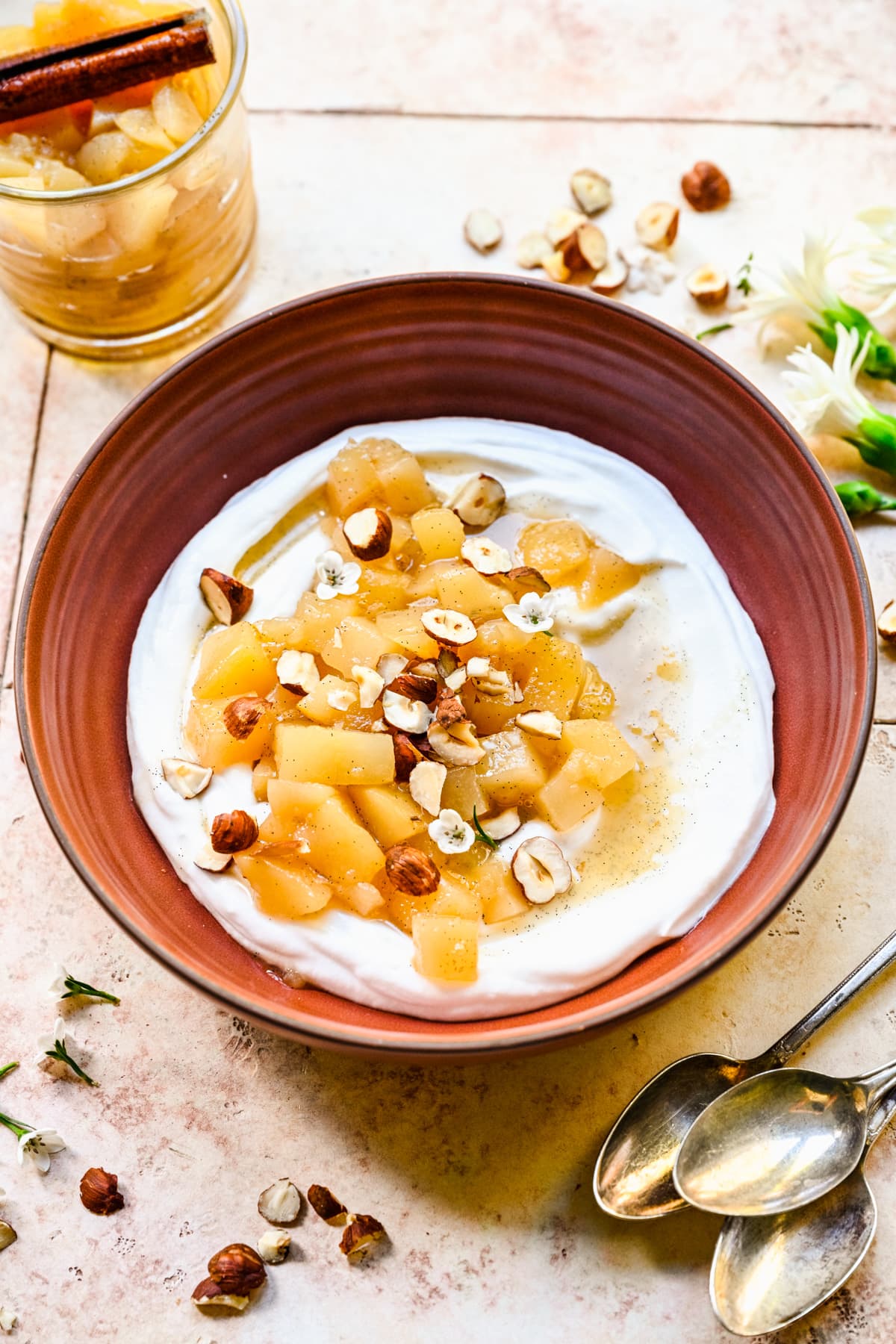 Overhead view of stewed pears atop yogurt in a bowl.