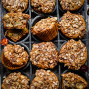 Overhead view of vegan apple muffins in a muffin tin.