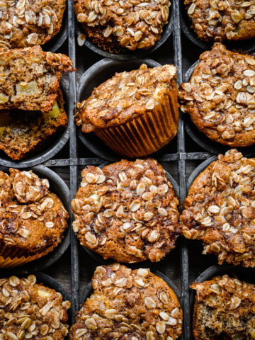 Overhead view of vegan apple muffins in a muffin tin.