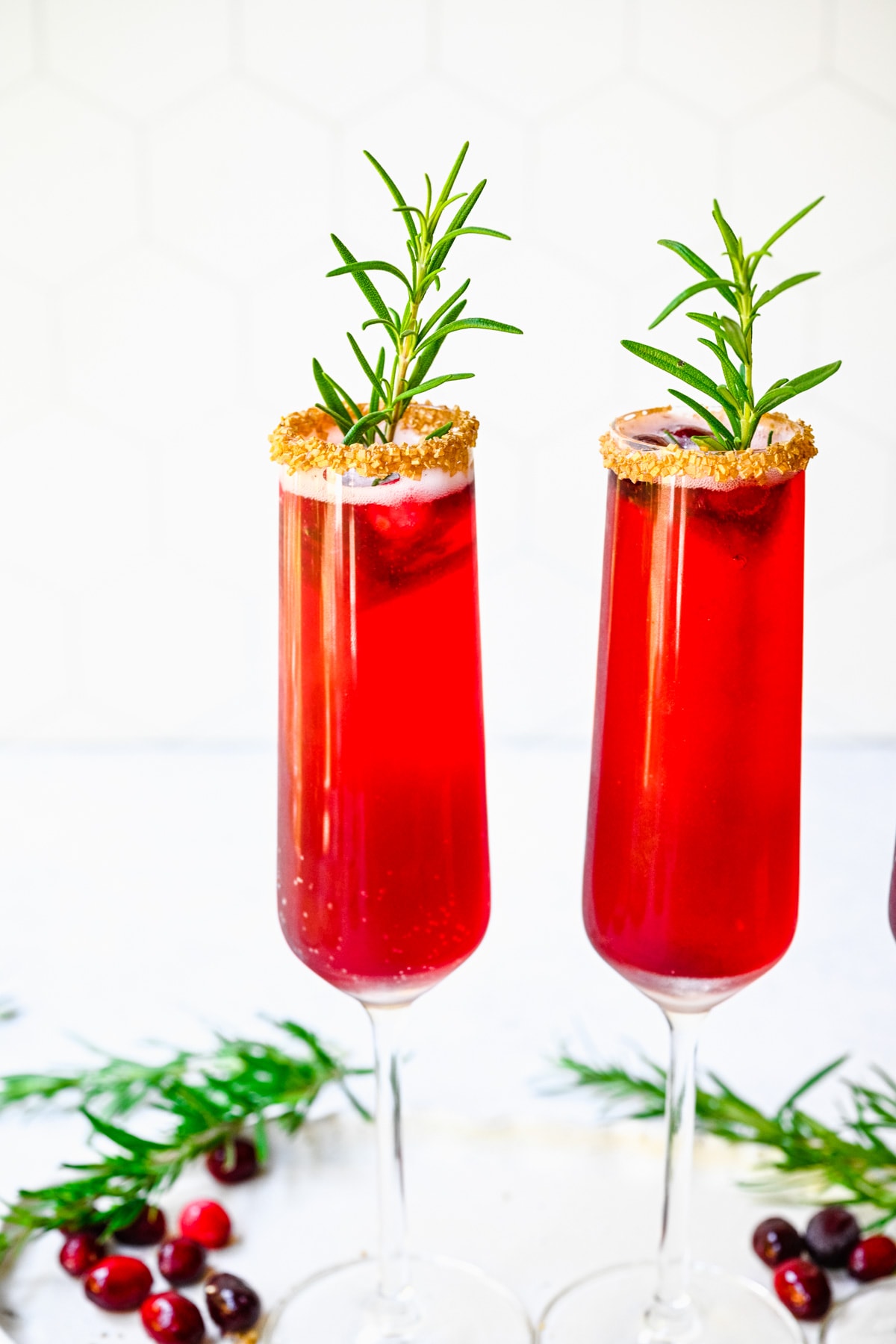 Two of the finished cranberry mimosas in glasses.