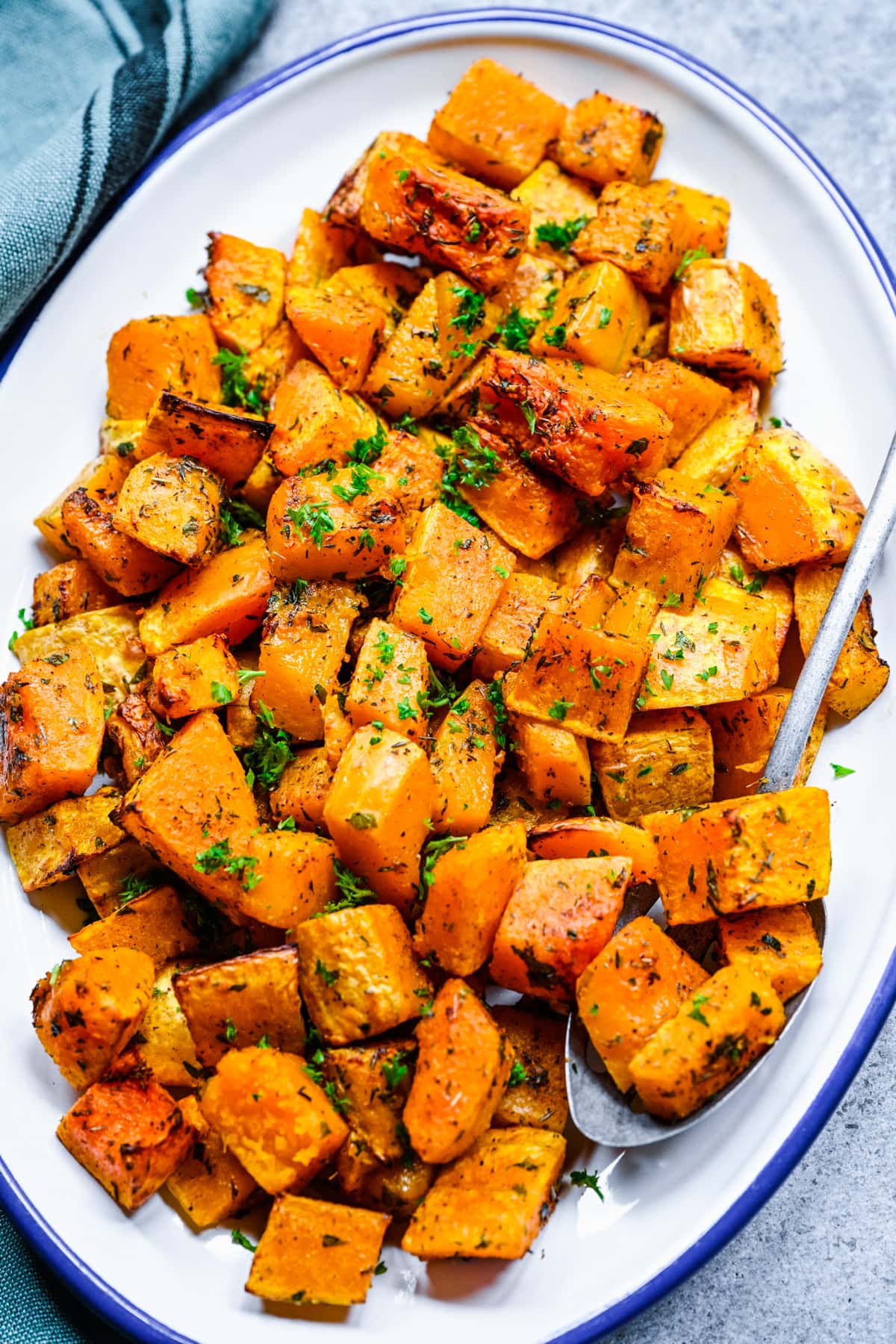 Finished air fryer butternut squash on a white platter.