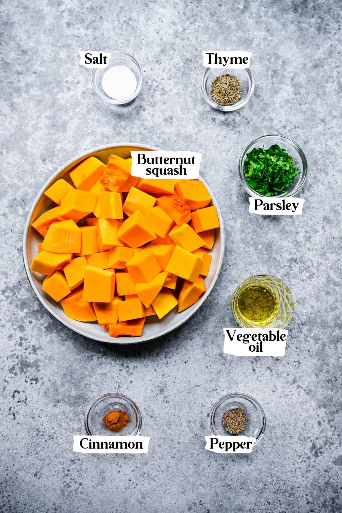 Air fryer butternut squash ingredients including thyme and butternut squash.