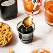 Close up of finished brown sugar simple syrup in a spoon.