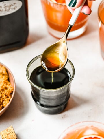 Close up of finished brown sugar simple syrup in a spoon.