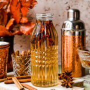 Finished cinnamon simple syrup in a glass bottle.