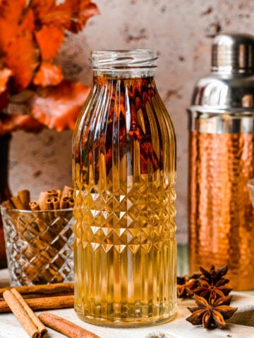 Finished cinnamon simple syrup in a glass bottle.