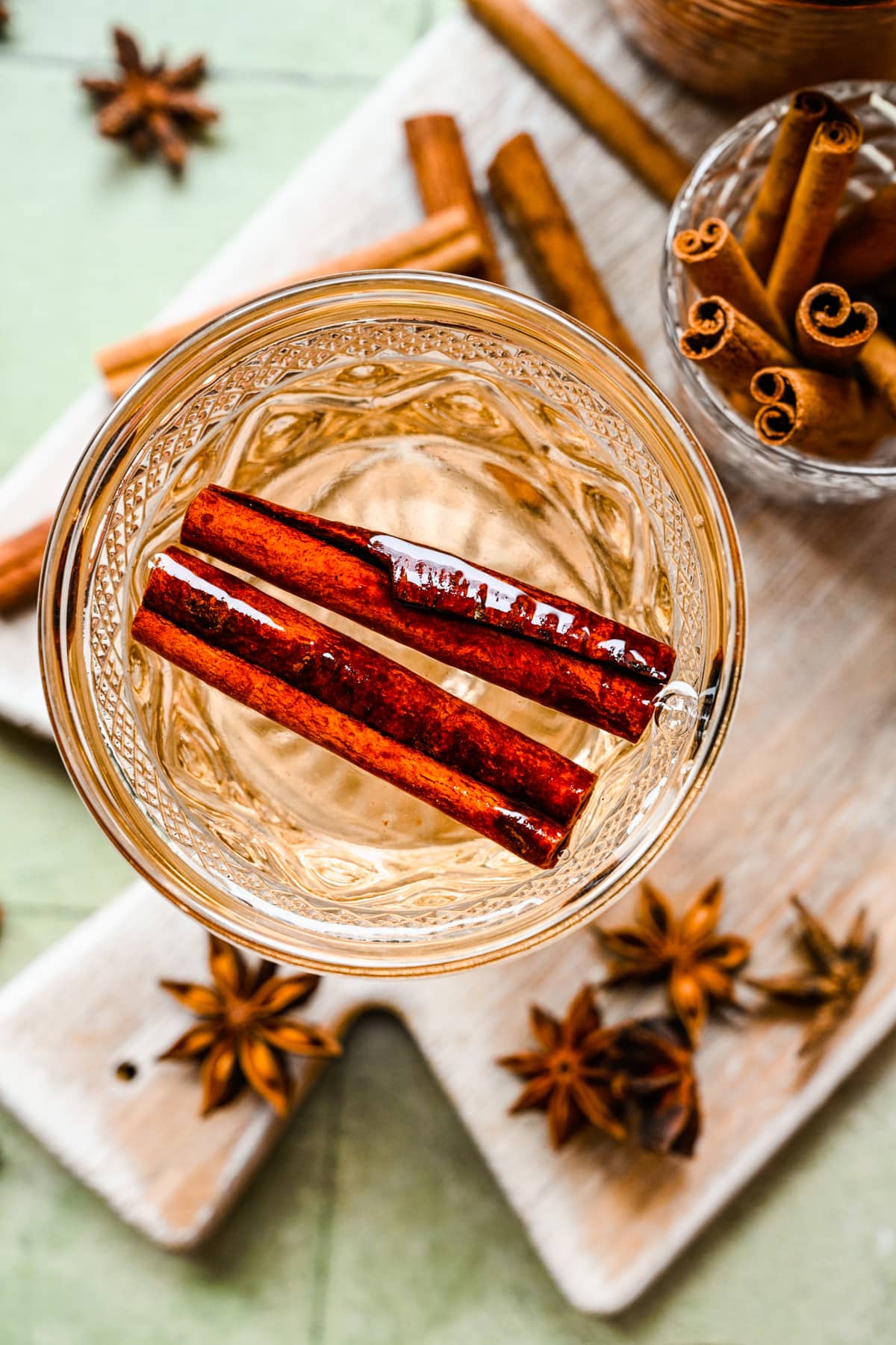 Overhead of the cinnamon simple syrup with cinnamon sticks in it.