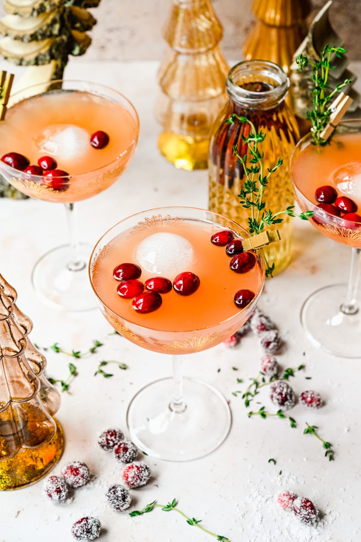 Finished cranberry mocktails in glasses with garnish and festive background.