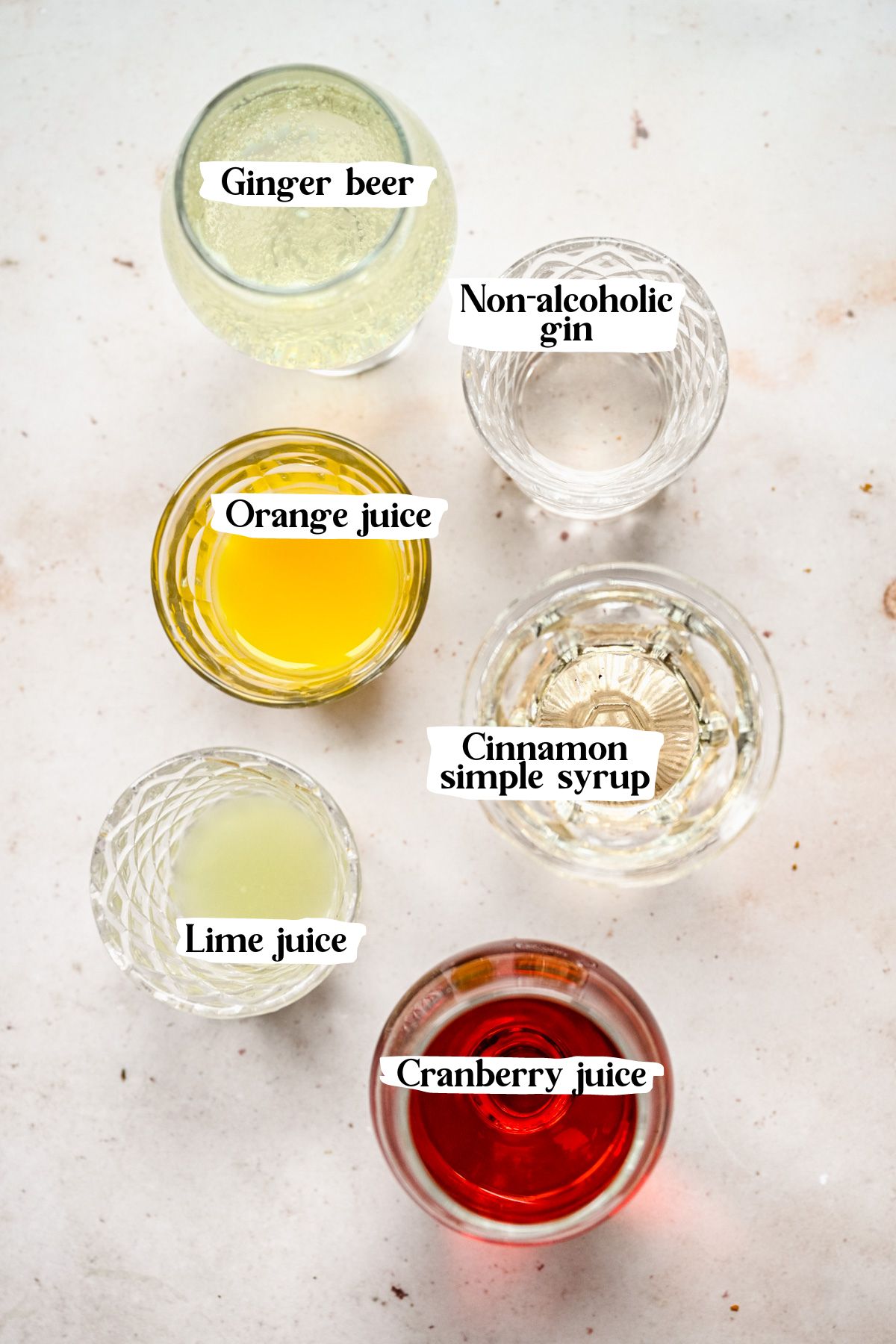 Cranberry mocktail ingredients including lime juice and orange juice.