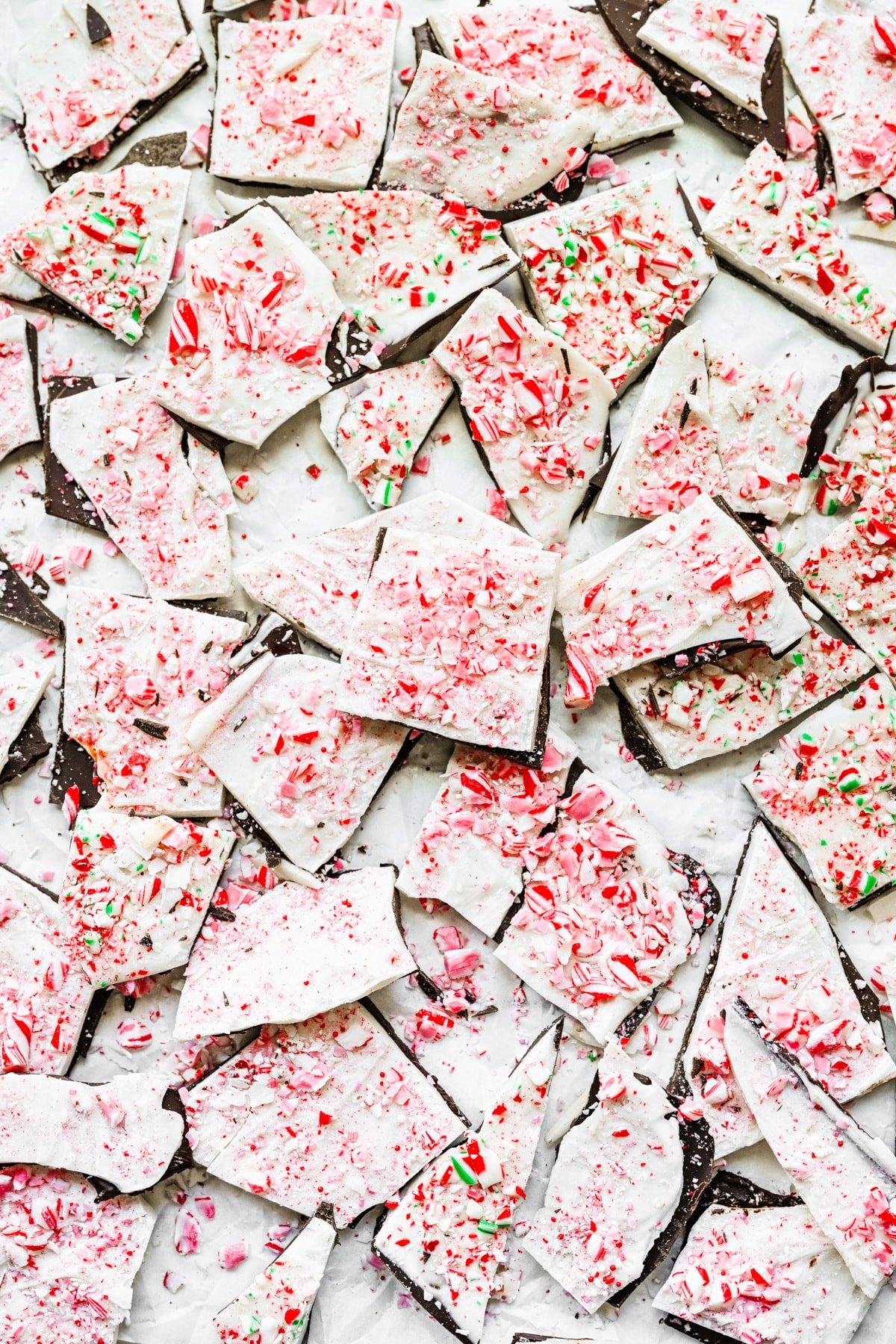 Peppermint bark spread out on a white background.