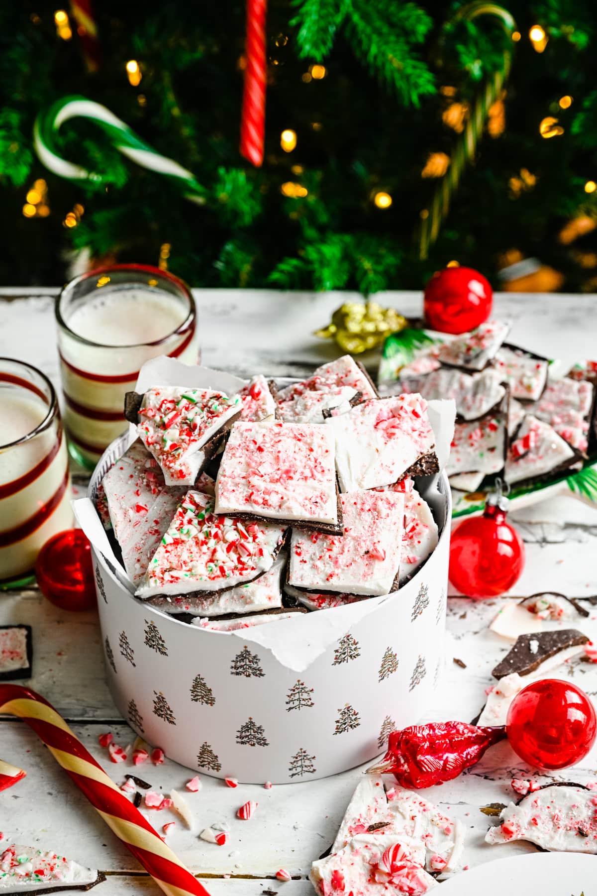 Finished peppermint bark in a gift basket by tree.
