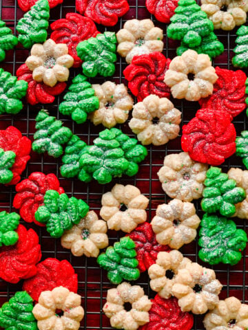 Overhead of the finished vegan spritz cookies on a baking rack.