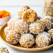 Close up of the finished apricot bliss balls on a plate.