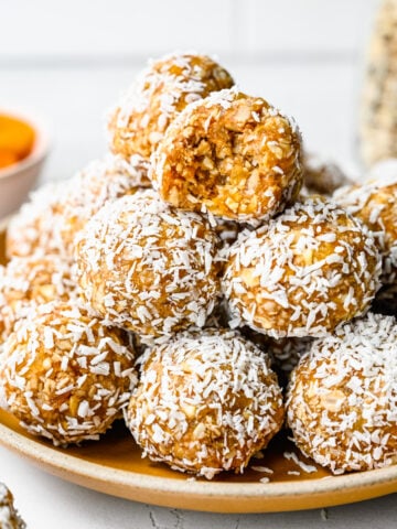 Close up of the finished apricot bliss balls on a plate.