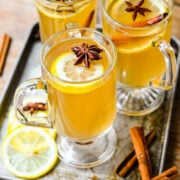 Overhead view of the finished hot toddy cocktails with lemon slices on top.