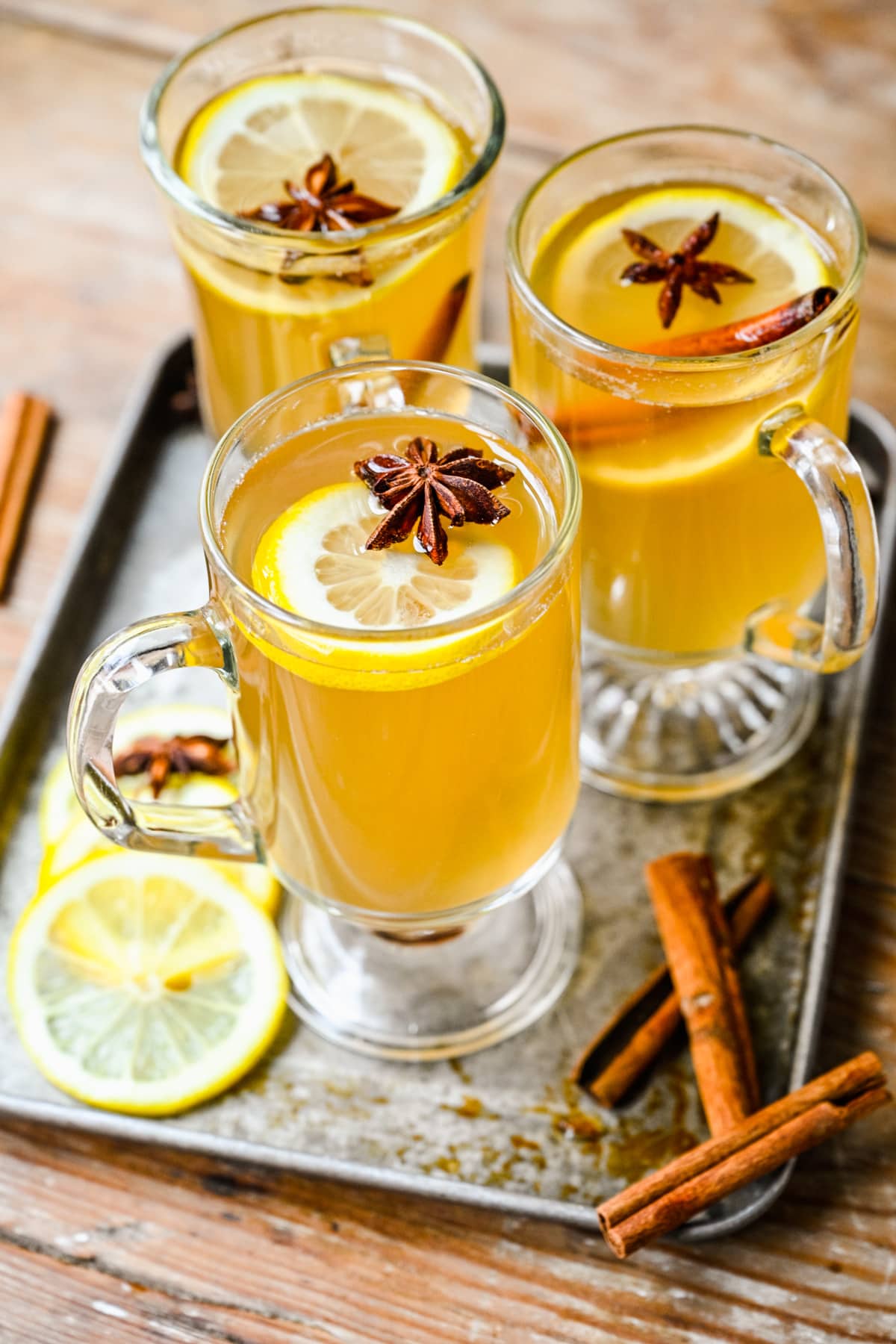 Overhead view of the finished hot toddy cocktails with lemon slices on top.