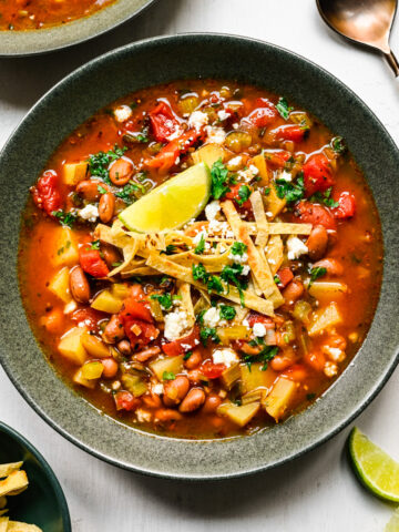 Overhead view of the finished pinto bean soup topped with tortilla strips.