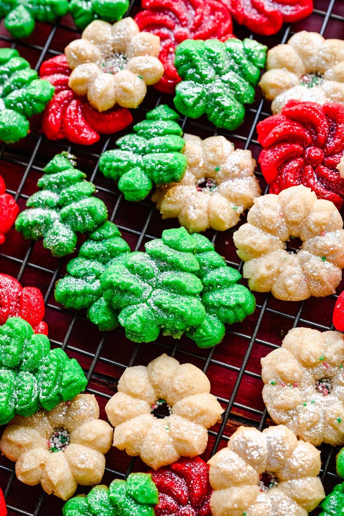 close up view of vegan spritz cookies on baking sheet.