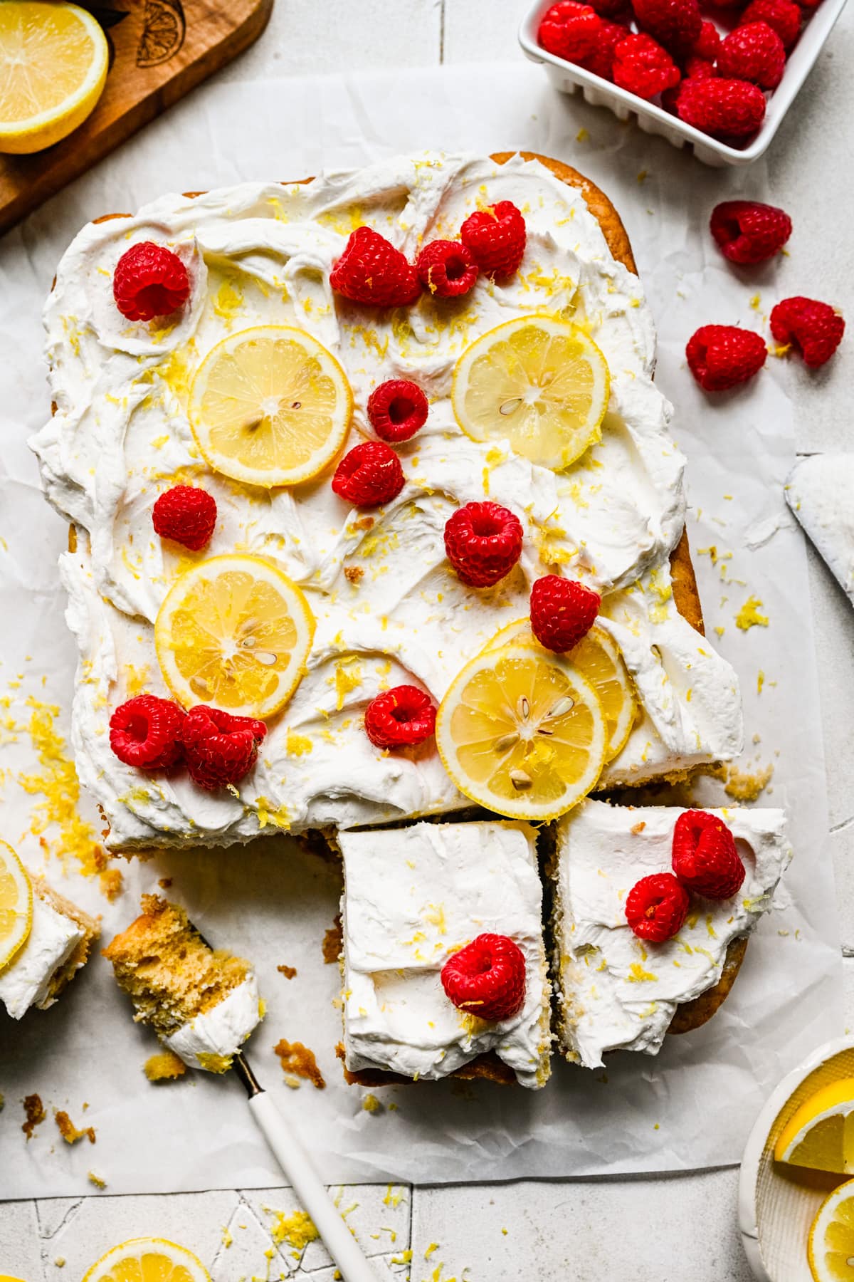 Overhead view of lemon cake with raspberries on top.