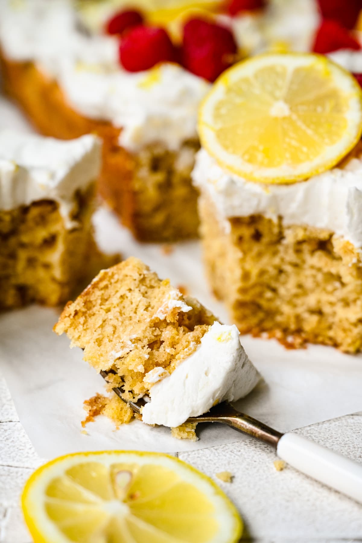 Close up view of lemon cake on a fork.