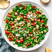 Overhead of the finished spinach chickpea salad in a white bowl.