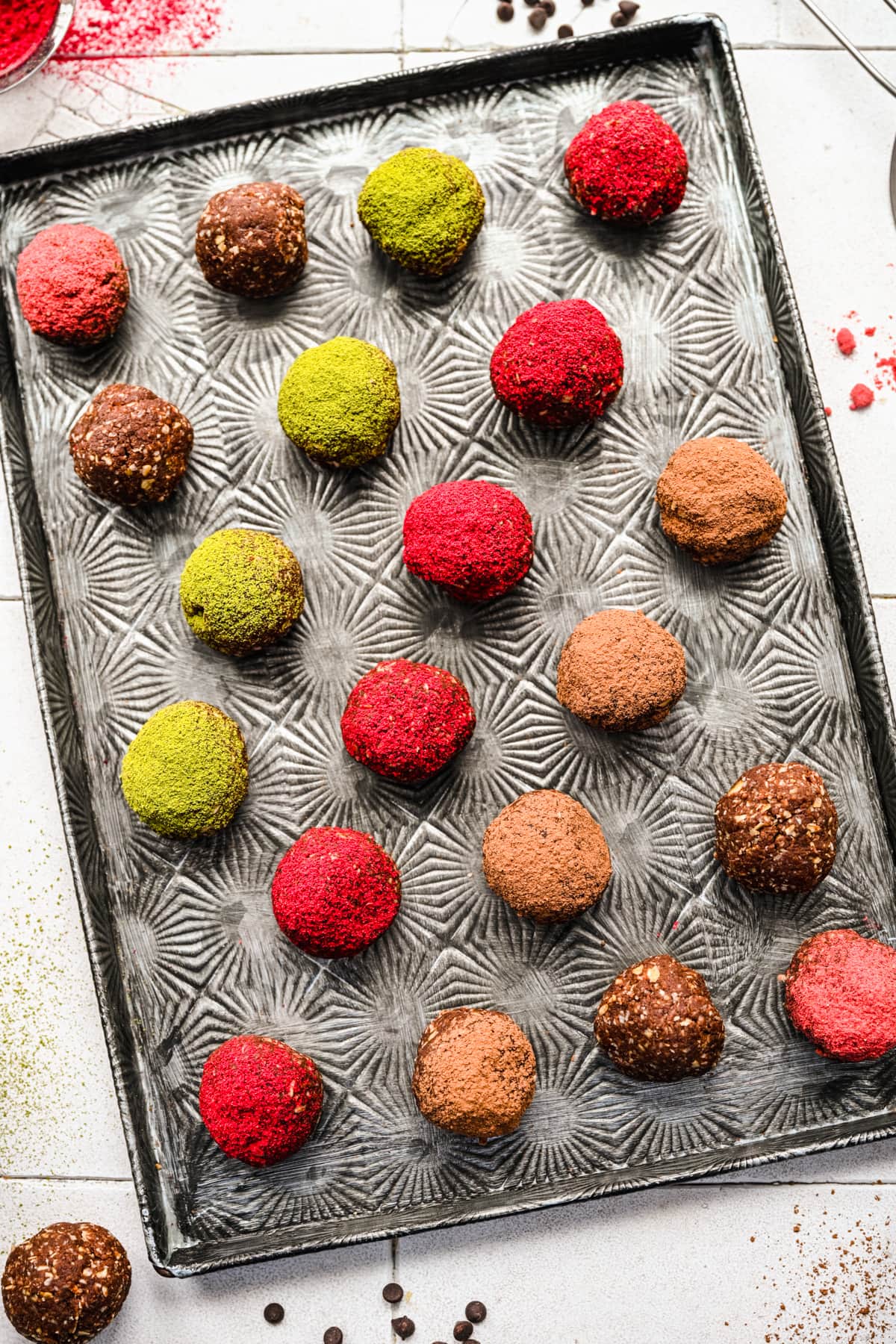 Overhead of the finished chocolate bliss balls on a silver tray.