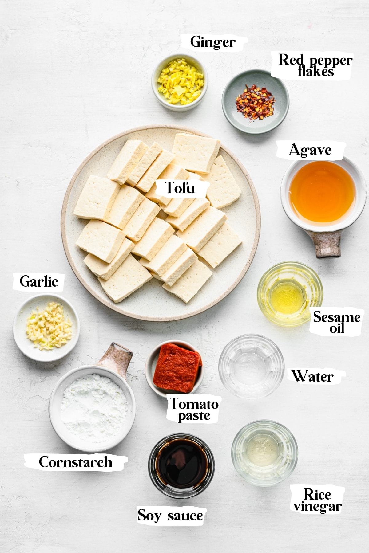 overhead view of ingredients for sticky tofu in small prep bowls.