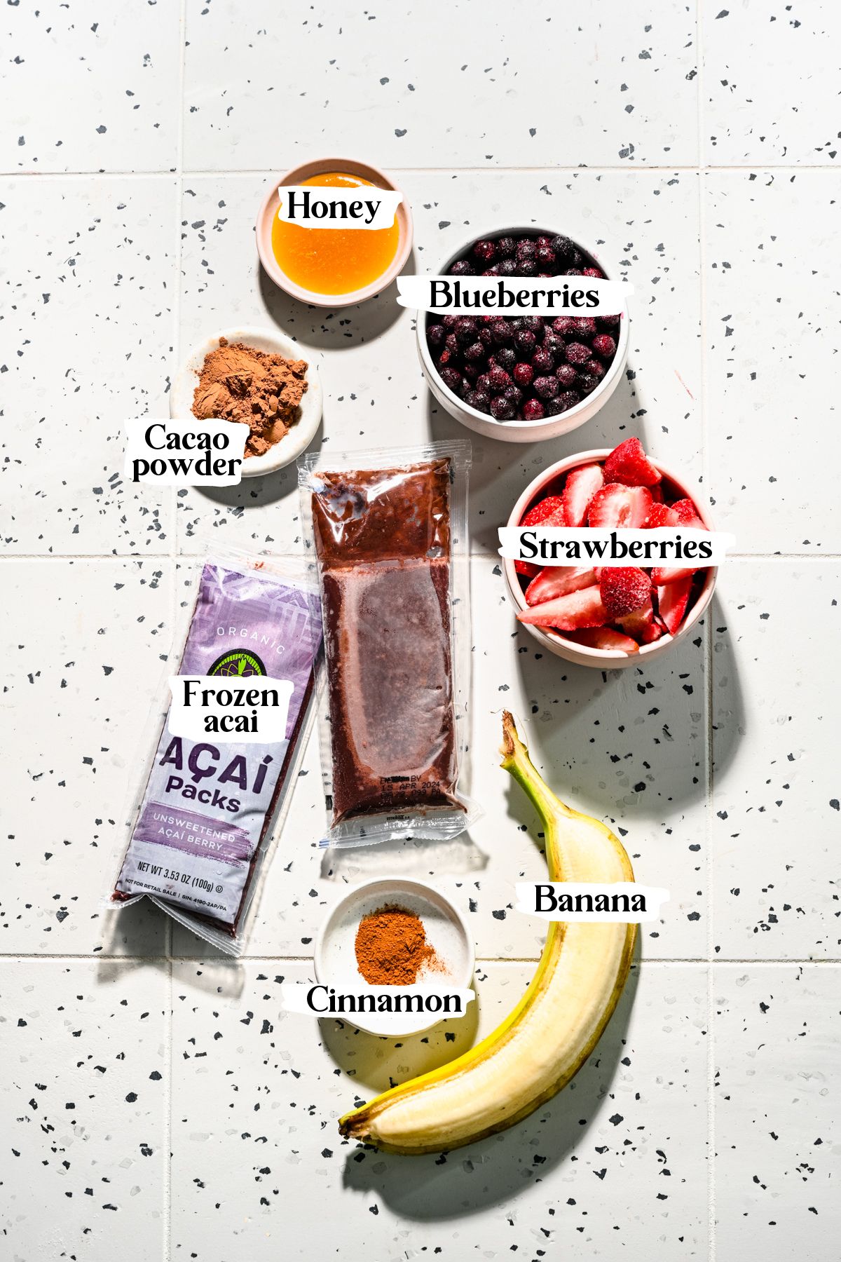 Chocolate acai bowl ingredients including banana and cacao powder.