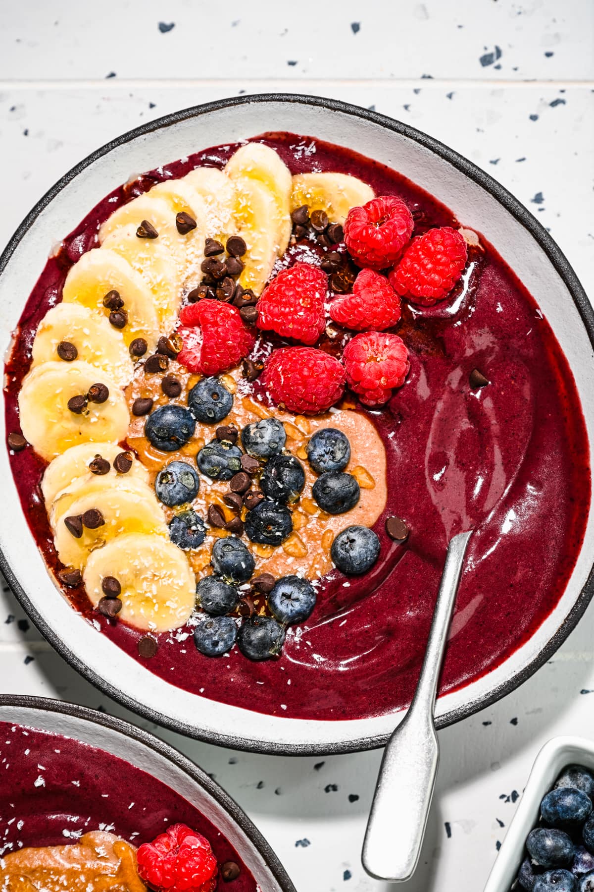 Overhead close up of the acai bowls with toppings.