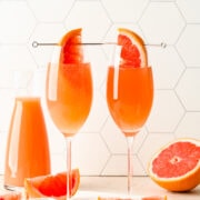 Close up of the finished grapefruit mimosas with a grapefruit wedge in it.