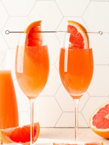 Close up of the finished grapefruit mimosas with a grapefruit wedge in it.