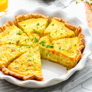 Overhead view of leek and squash quiche cut into slices.