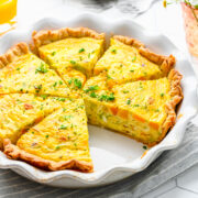 Overhead view of finished leek and squash quiche cut into slices.