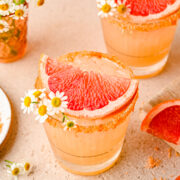 Overhead of the paloma cocktail topped with a slice of grapefruit and a rim.