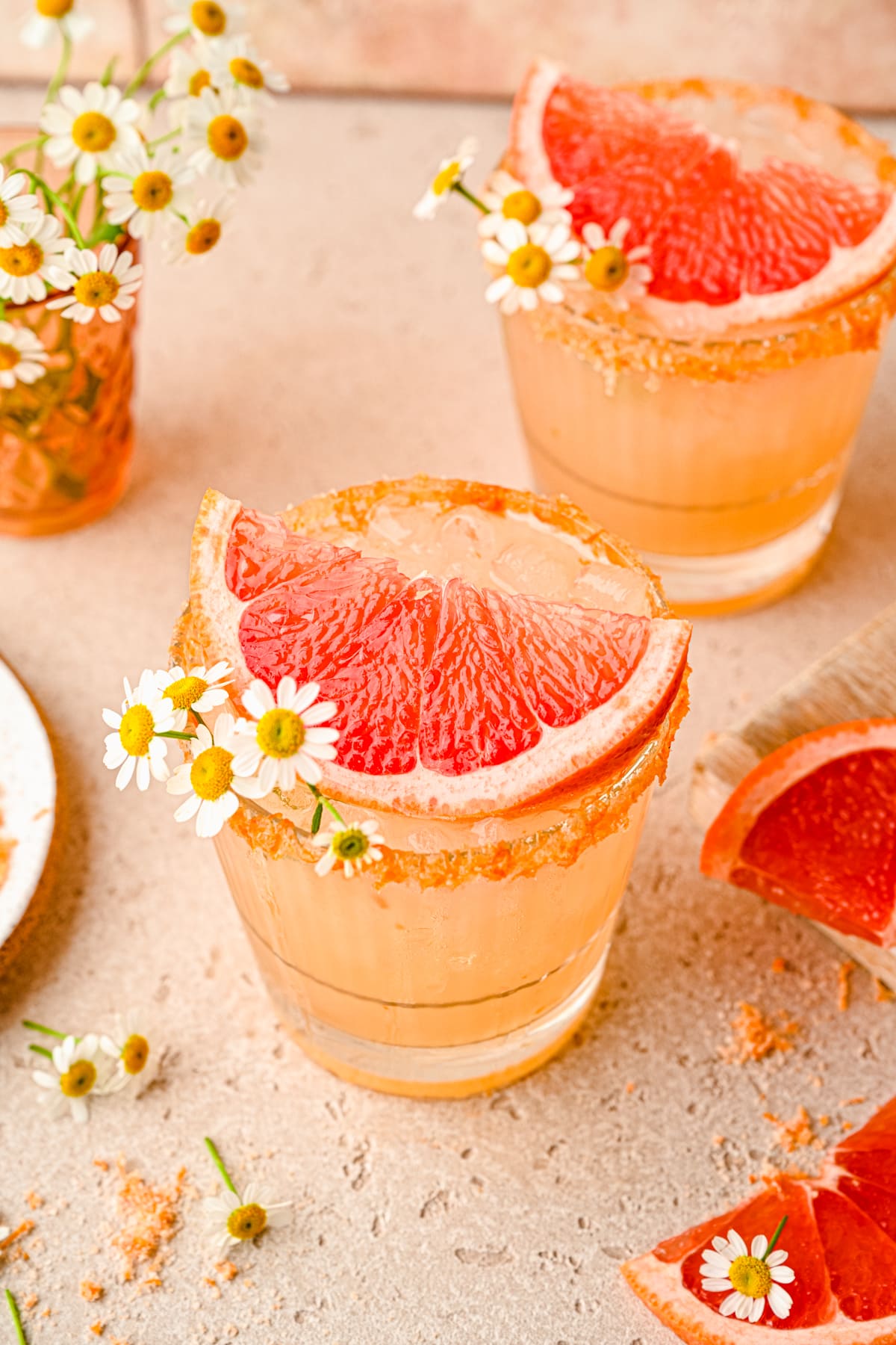 Overhead of the paloma cocktail topped with a slice of grapefruit and a rim.