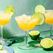 Finished rum margaritas with lime slice garnish.
