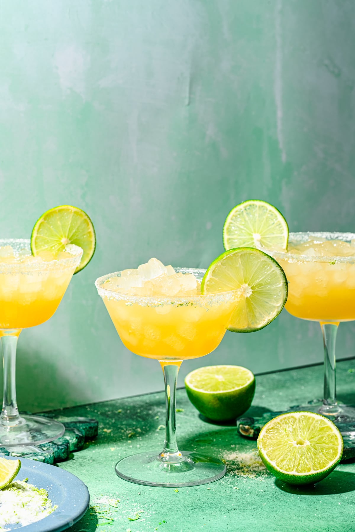 Finished rum margaritas in glasses with lime garnish and salt rim.