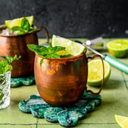 Finished rum moscow mules in copper mugs with lime and mint garnish.