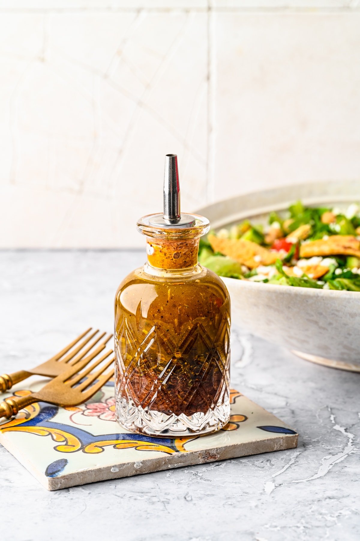 Finished sumac dressing in a glass bottle ready to use on a salad.