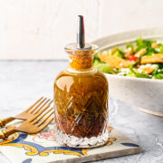 Finished sumac dressing in a glass bottle.