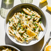 Overhead of the finished lemon pasta plated and served with wine.