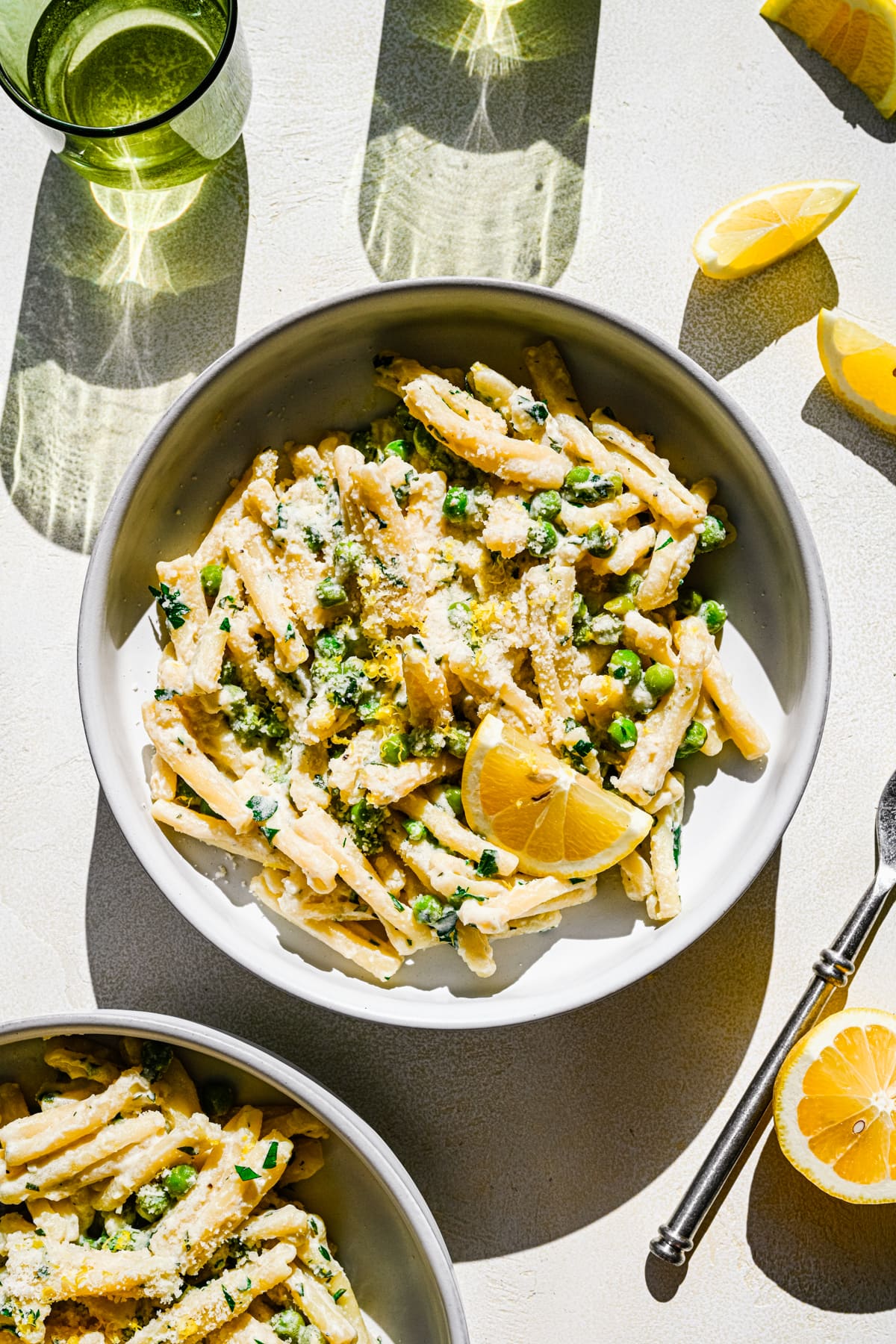 Overhead of the finished lemon pasta plated and served with wine.