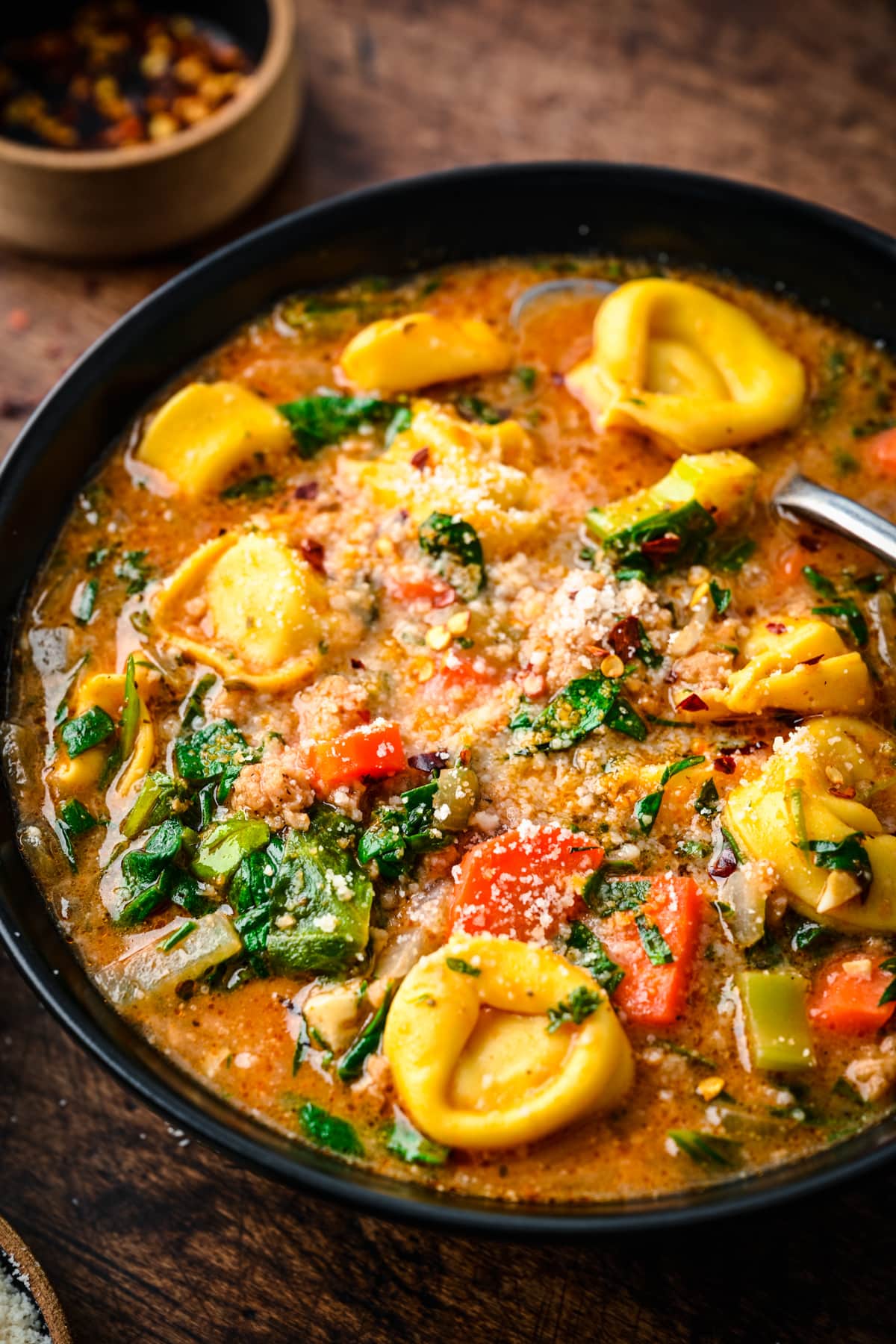 Slight overhead of the finished vegan tortellini soup in a bowl.