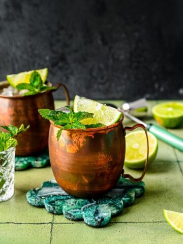 Finished rum Moscow mules with mint and lime garnish in it.