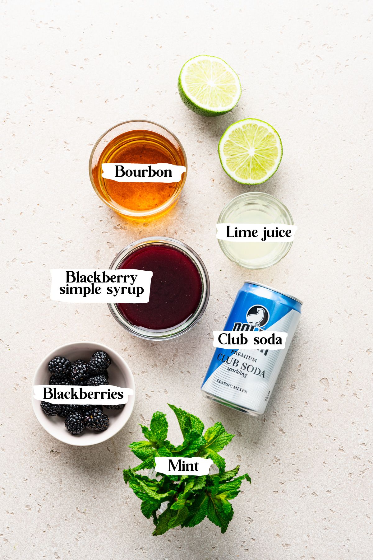 Blackberry bourbon smash ingredients including lime juice and blackberries.