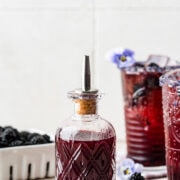 Finished blackberry simple syrup in a glass jar.