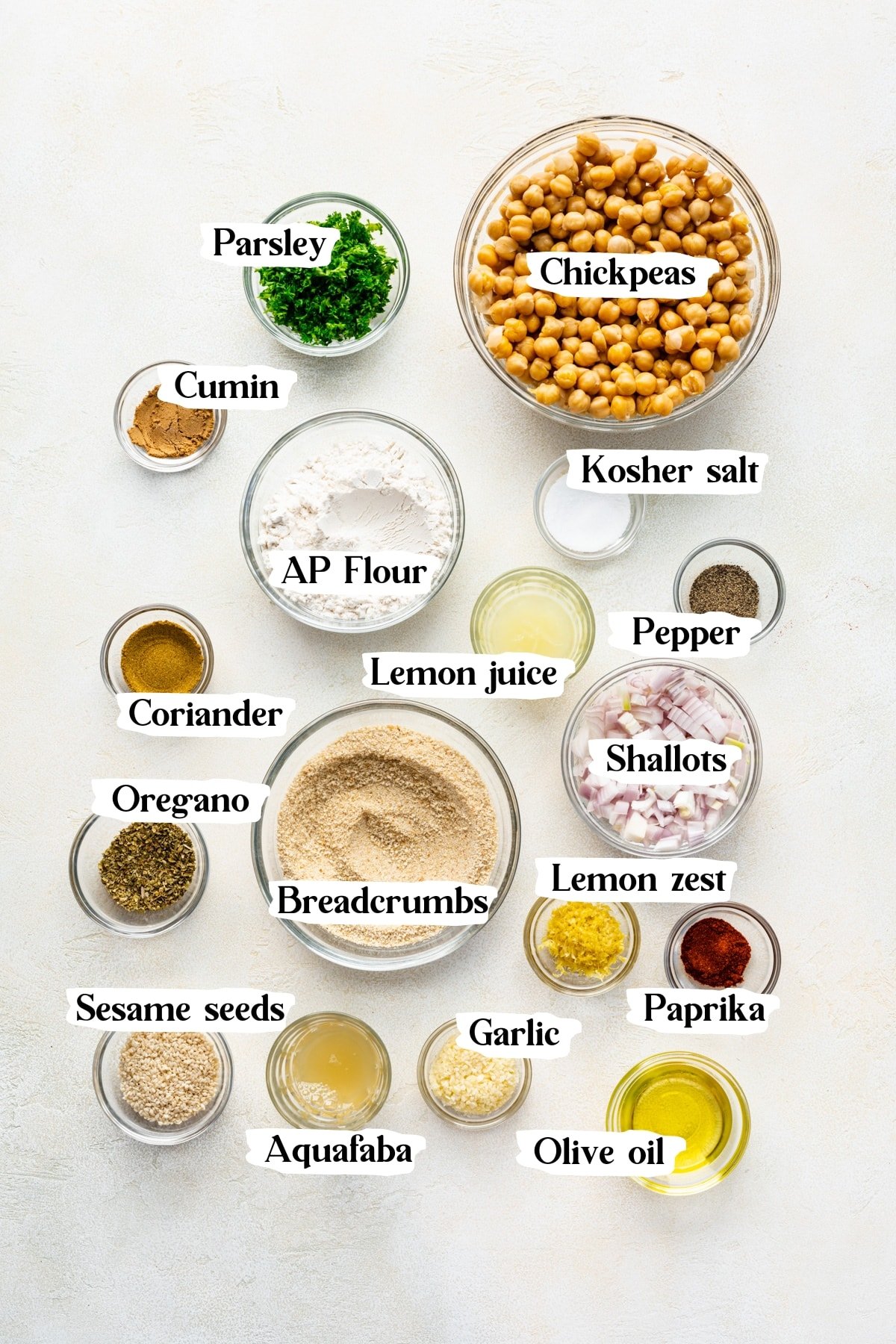 Vegan chickpea fritter ingredients: parsley, chickpeas, cumin, ap flour, kosher salt, pepper, lemon juice, coriander, oregano, breadcrumbs, shallots, lemon zest, paprika, sesame seeds, aqua faba, garlic, olive oil.